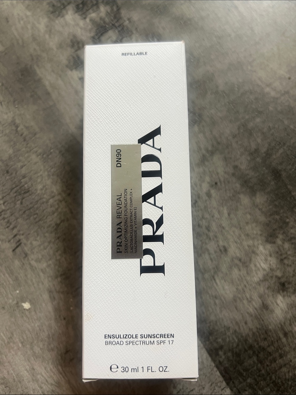 Prada Reveal Ensulizole Sunscreen SPF 17 in White and Gold Accents